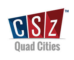 Comedy Sportz logo with a blue box behind a letter C and two red boxes behind the letters S and Z and text that reads Quad Cities